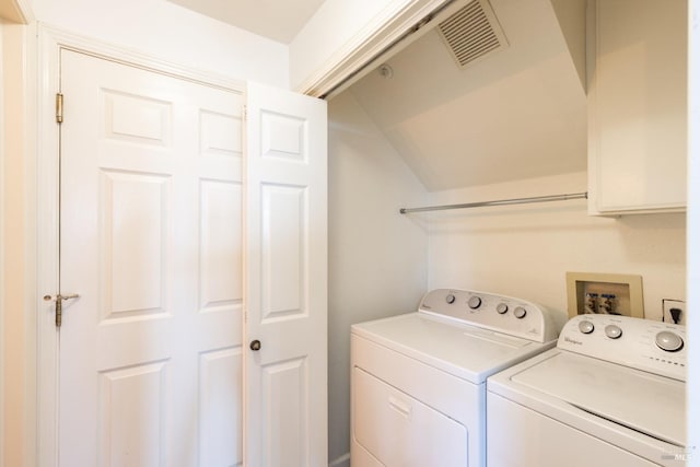 laundry area with laundry area, washing machine and dryer, and visible vents