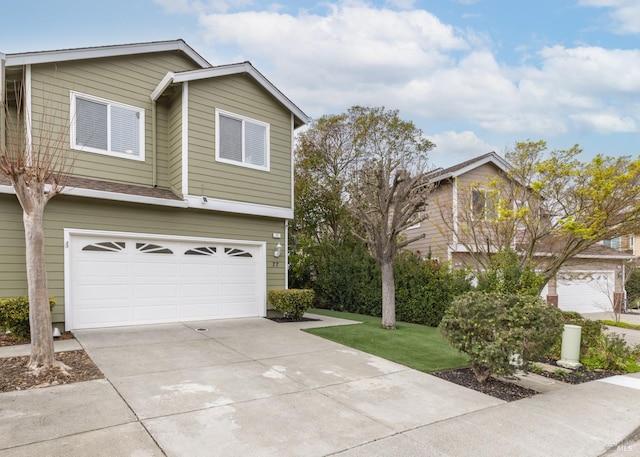 view of front facade with concrete driveway and an attached garage