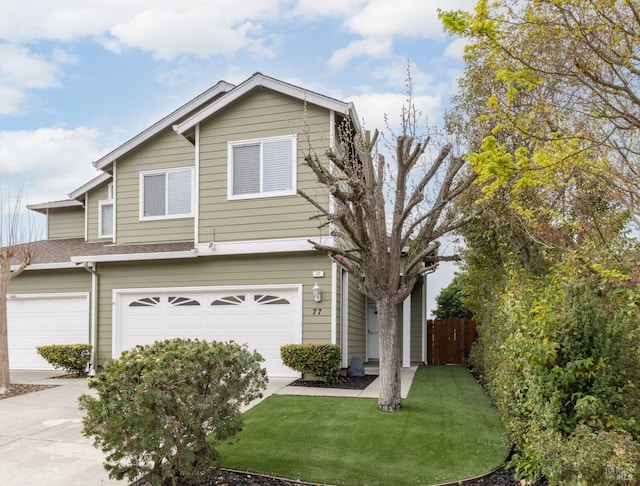 view of front of house featuring roof with shingles, a front yard, fence, a garage, and driveway