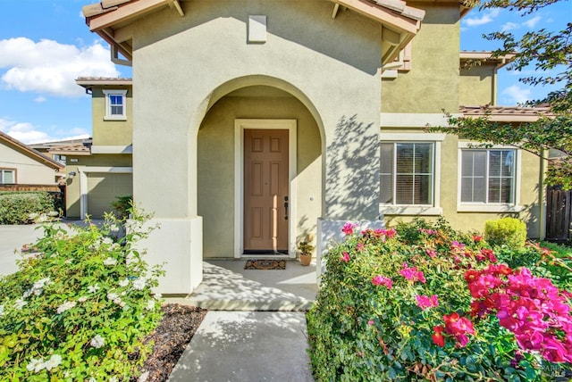 entrance to property with stucco siding