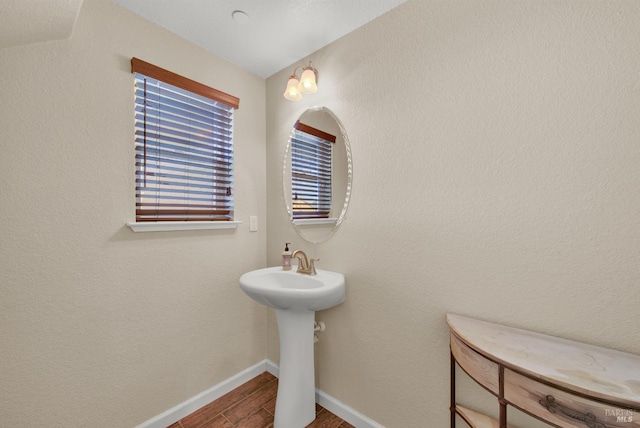 bathroom featuring wood finished floors and baseboards