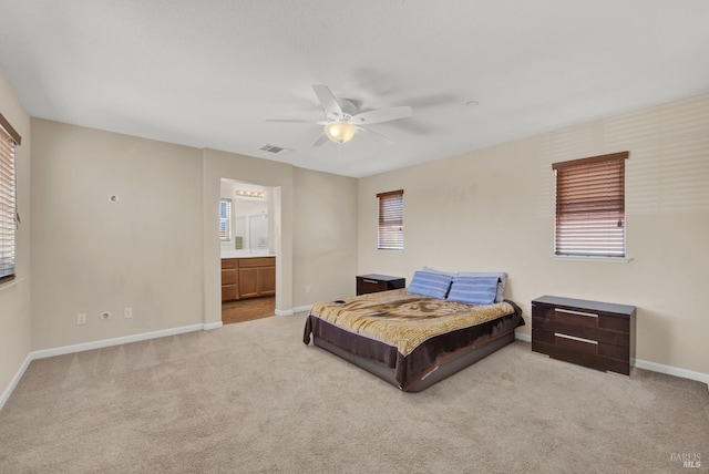 carpeted bedroom with visible vents, multiple windows, baseboards, and a ceiling fan