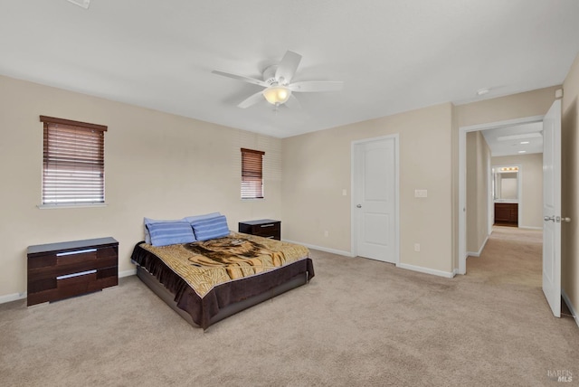 carpeted bedroom with ceiling fan and baseboards