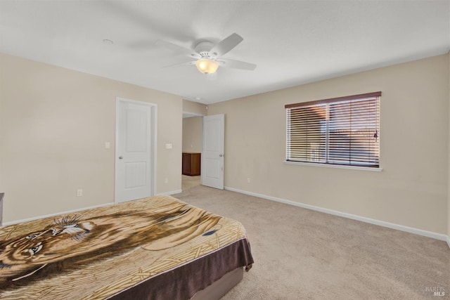 bedroom featuring light carpet, ceiling fan, and baseboards