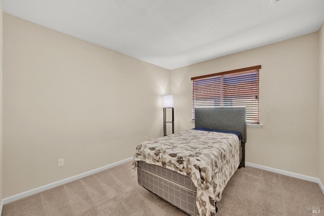 bedroom featuring carpet floors and baseboards