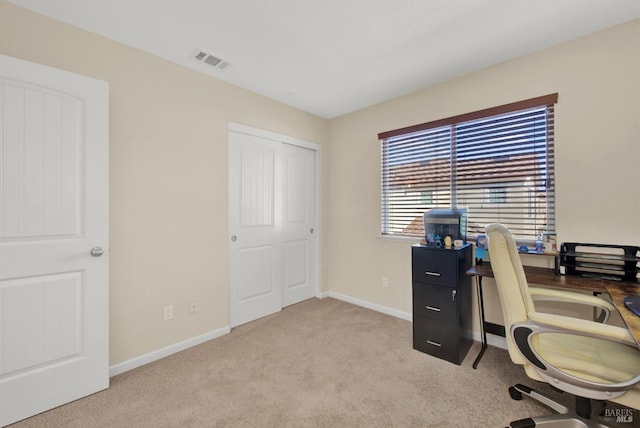 carpeted office space featuring visible vents and baseboards