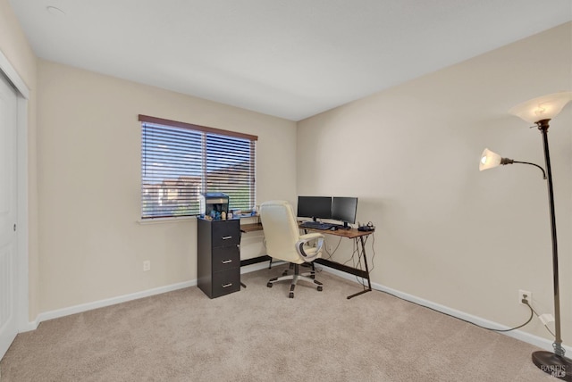 home office featuring baseboards and light colored carpet