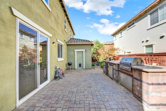 view of patio / terrace featuring area for grilling, grilling area, and fence