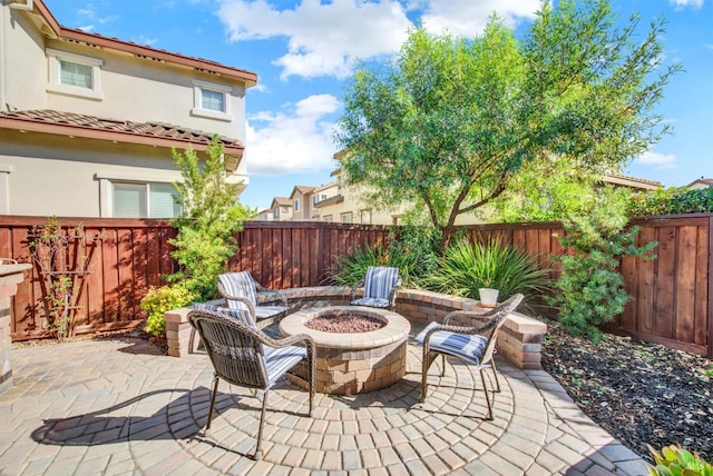 view of patio featuring an outdoor fire pit and a fenced backyard