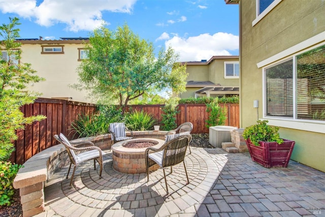 view of patio / terrace featuring an outdoor fire pit and a fenced backyard