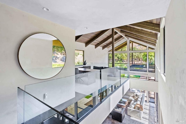 interior space with lofted ceiling with beams and wooden ceiling