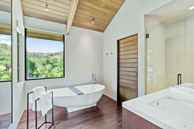 full bath with a soaking tub, lofted ceiling with beams, an enclosed shower, wood finished floors, and wooden ceiling