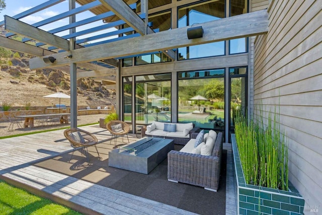view of patio with outdoor dining area, an outdoor living space with a fire pit, a wooden deck, and a pergola