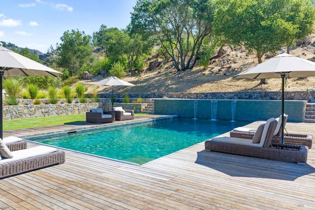 view of swimming pool with a fenced in pool, a wooden deck, and an outdoor hangout area