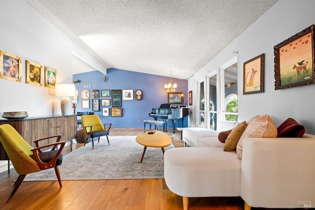 living room with lofted ceiling with beams, a textured ceiling, a notable chandelier, and wood finished floors