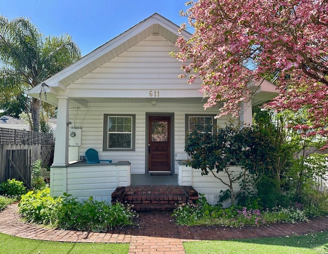 view of front of house with fence and a porch