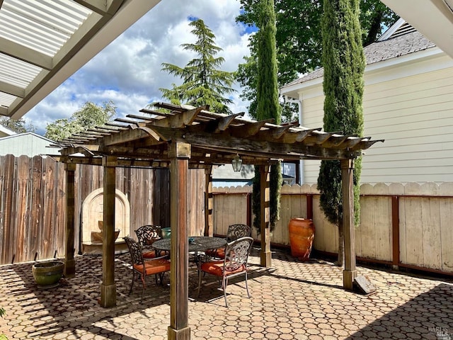 view of patio / terrace featuring fence, a pergola, and outdoor dining space