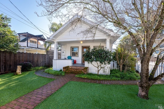 view of front of property featuring a porch, a front yard, fence, and a pergola
