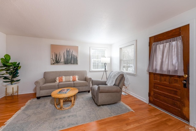 living area featuring light wood-style flooring and baseboards