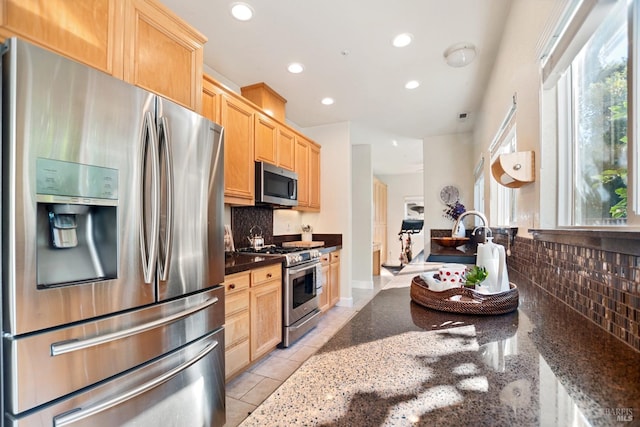 kitchen featuring plenty of natural light, stainless steel appliances, light brown cabinets, backsplash, and recessed lighting