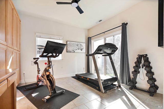 workout room with ceiling fan, light tile patterned floors, visible vents, and baseboards