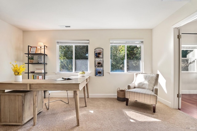 carpeted office featuring baseboards and visible vents