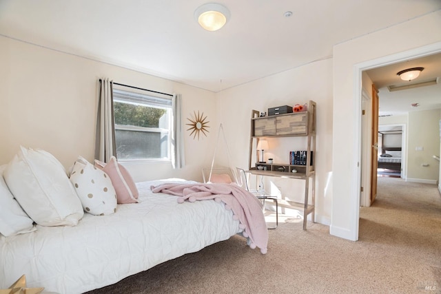 carpeted bedroom featuring baseboards