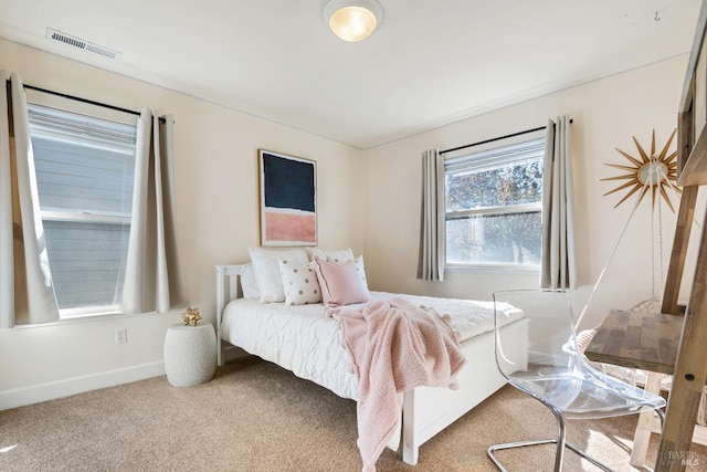 carpeted bedroom featuring visible vents and baseboards