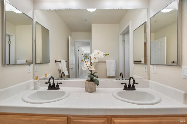 bathroom with double vanity and a sink