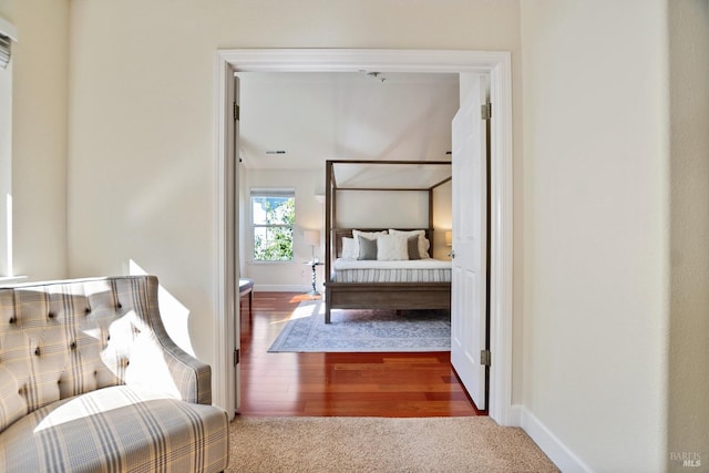 bedroom with visible vents, baseboards, and wood finished floors