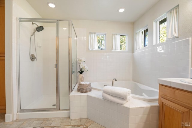 full bathroom with a stall shower, vanity, recessed lighting, and a bath