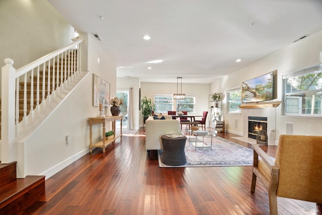 living area featuring hardwood / wood-style flooring, plenty of natural light, stairway, and visible vents