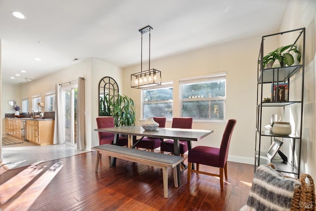 dining space featuring an inviting chandelier, baseboards, hardwood / wood-style floors, and recessed lighting