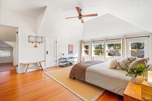 bedroom featuring high vaulted ceiling and light wood-type flooring