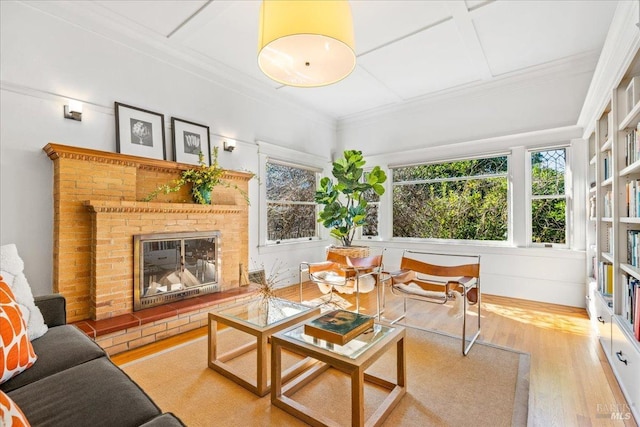 interior space with crown molding, a fireplace, and wood finished floors