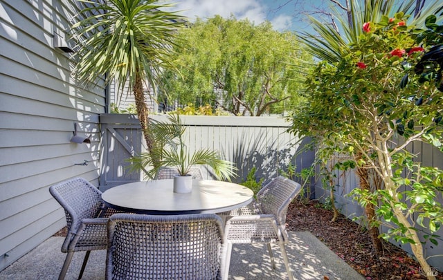 view of patio with outdoor dining space and a fenced backyard