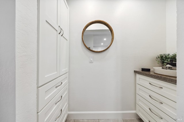 bathroom with vanity and baseboards