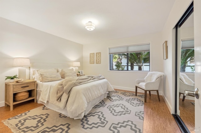 bedroom featuring baseboards and wood finished floors