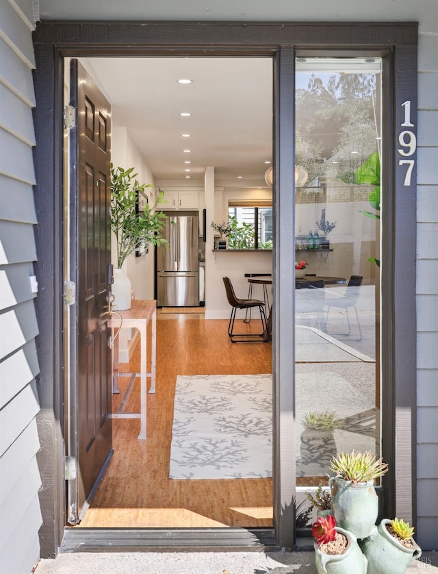 doorway to outside with recessed lighting and wood finished floors