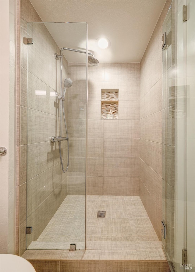 full bathroom with toilet and a shower stall