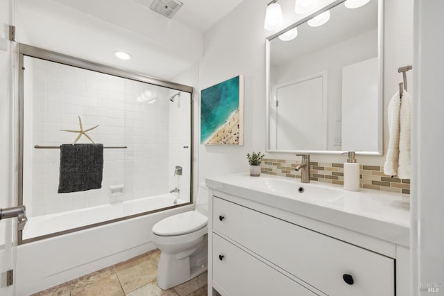 full bathroom featuring toilet, shower / bath combination, vanity, decorative backsplash, and tile patterned floors