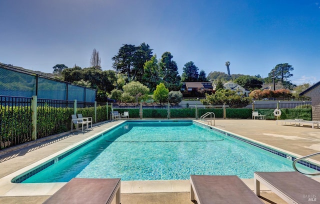 pool featuring a patio area and fence