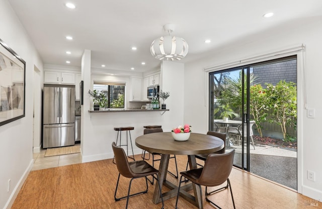 dining space with a wealth of natural light, baseboards, and recessed lighting