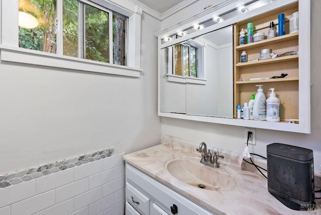 bathroom with ornamental molding and vanity