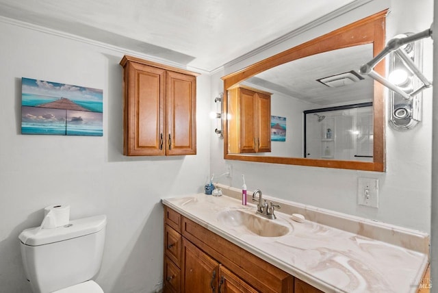 bathroom featuring a shower with door, vanity, and toilet