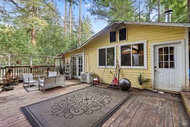 deck featuring ac unit, outdoor lounge area, and french doors