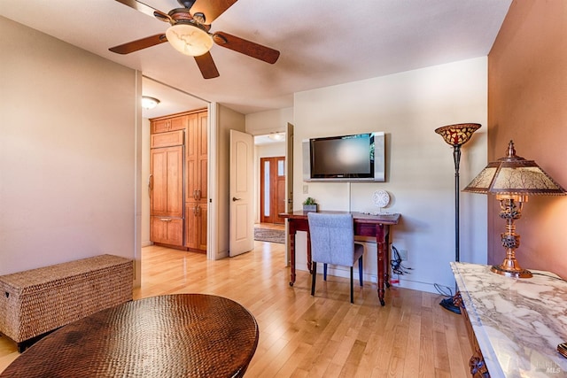 interior space with light wood-type flooring, ceiling fan, and baseboards