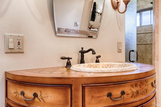 bathroom featuring a sink and a textured wall