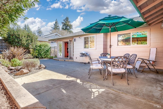 view of patio / terrace featuring outdoor dining area and fence