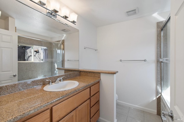 bathroom featuring vanity, a shower stall, visible vents, and tile patterned floors